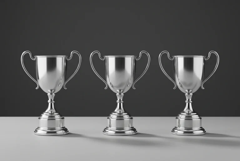 Three F1 trophy podium with three identical trophies side by side representing a tied championship outcome