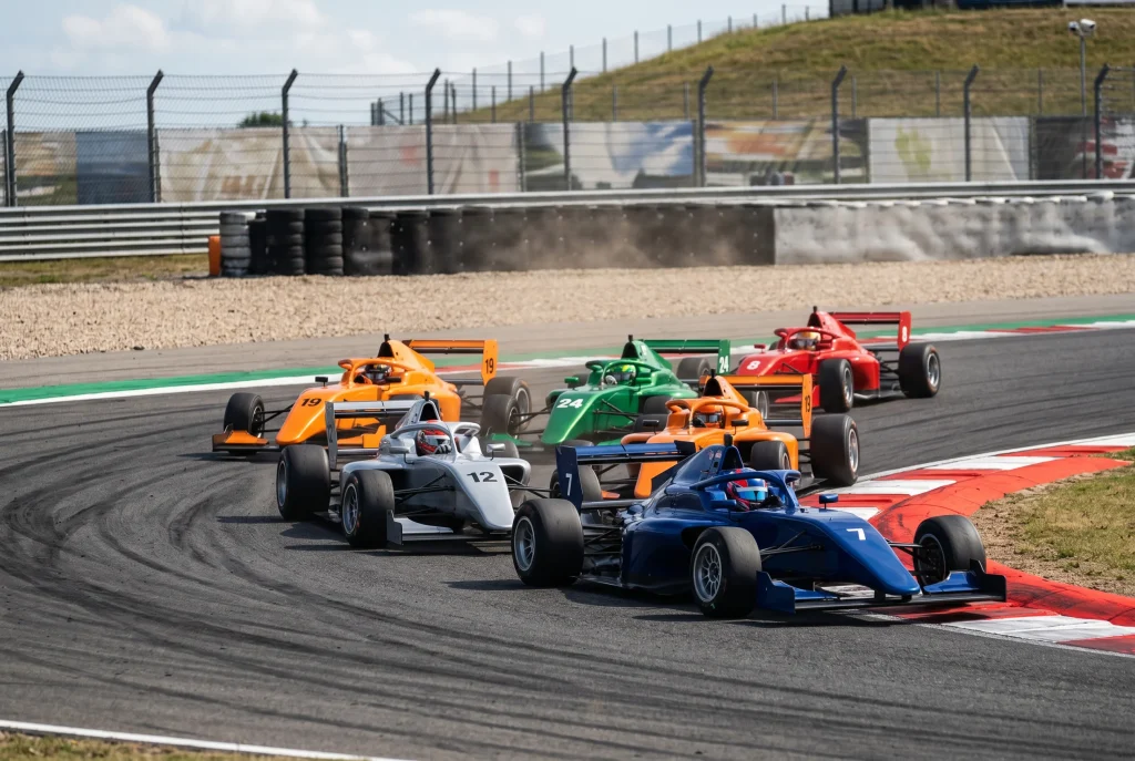 F1 midfield race cars battling for position through a chicane during a Grand Prix race