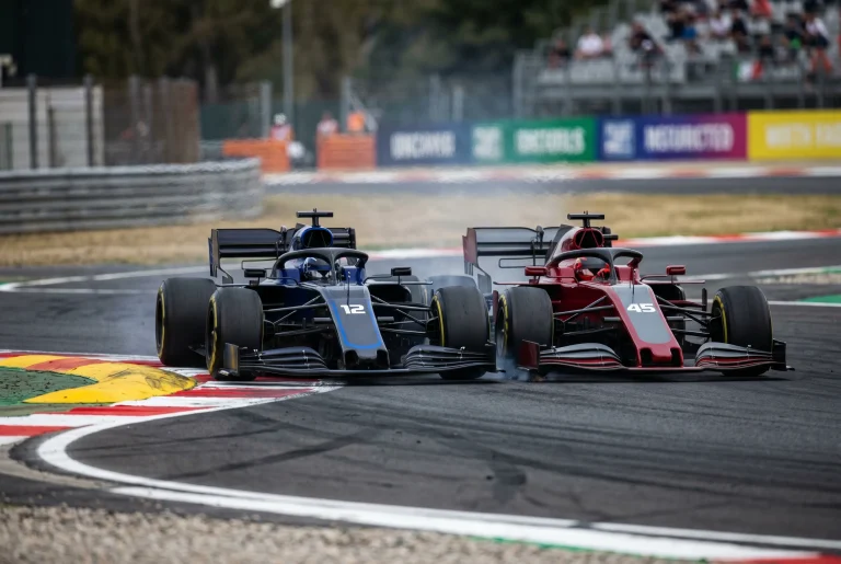 Two F1 race cars side by side battling wheel-to-wheel through a high-speed corner during a Grand Prix