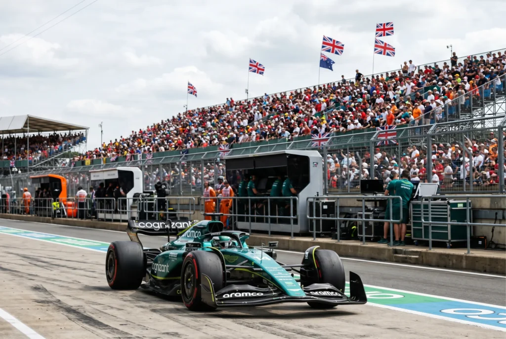 Formula 1 car on the pit lane at Silverstone with British grandstand crowds in the background
